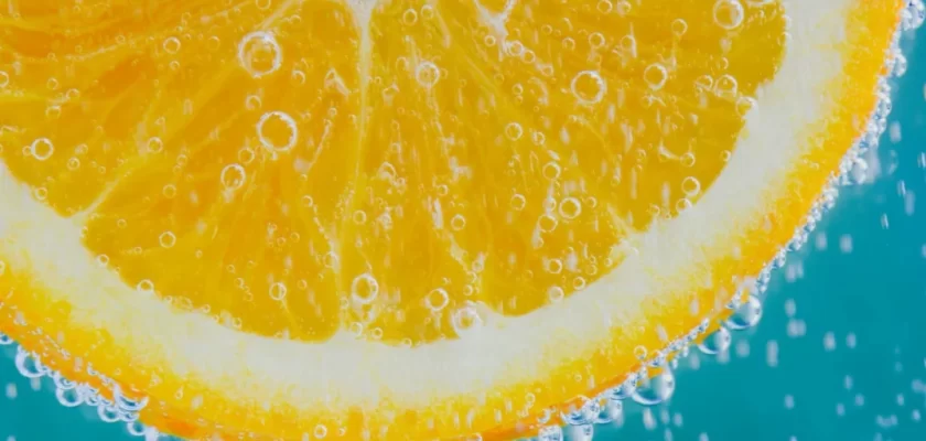 Close-up of juicy fruit slice with water droplets glistening on the surface