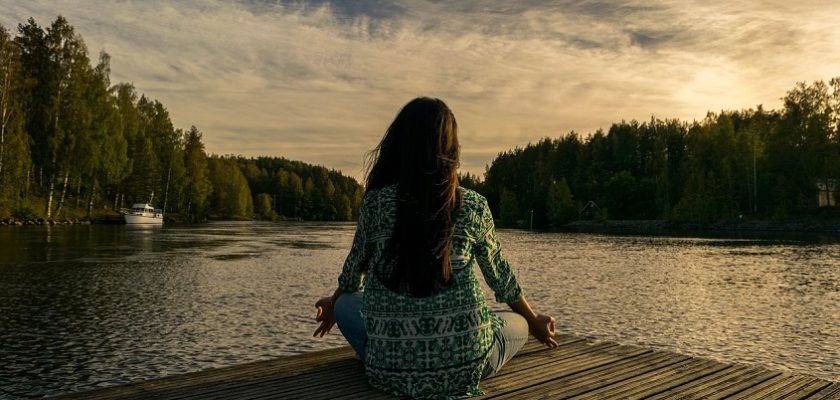 woman mindfulness and meditation on river